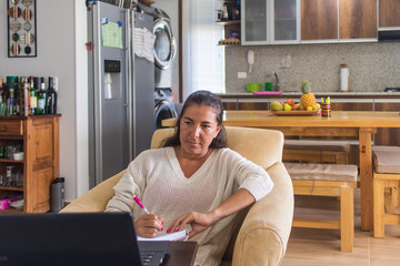 business woman working from home with the kitchen at the background