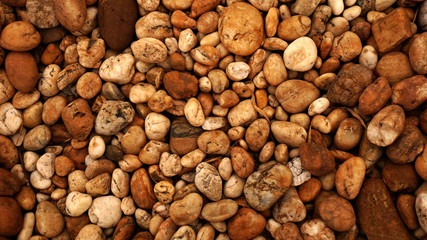 brown small stone background. pebble beach stone garden