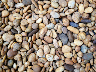 brown small stone background. pebble beach stone garden