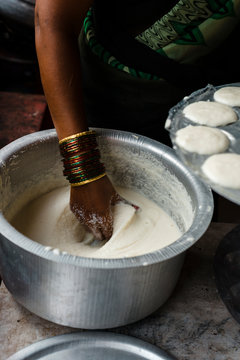 Hand of ethnic woman preparing Indian Idly