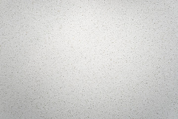 White quartz background countertop. This light background is taken from a bright off-white quartz kitchen counter. The subtle texture can be used as surface or table backdrop graphic design element.