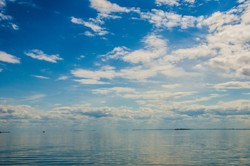 Blue sea and sunny sky with clouds