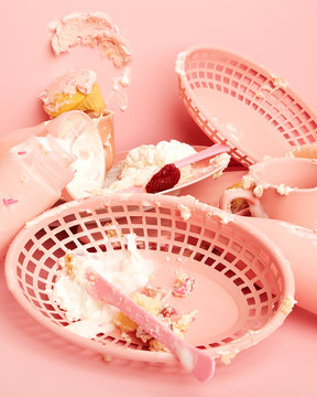 Smashed Dessert Mess Still Life on Pink; Dirty Monochromatic Dishes with Cake