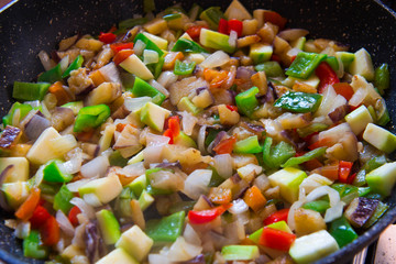 Assorted fresh vegetables in a frying pan. Vegetables cooked on the stove