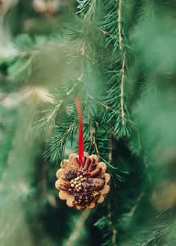 Decorating outdoors christmas tree with hanging cookies