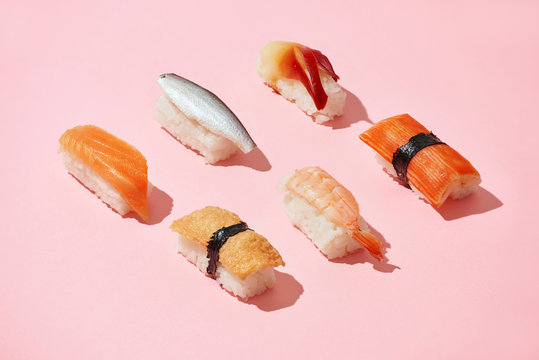 Sushi set of different nigiri idea, creative top on a pink background isolated - Powered by Adobe