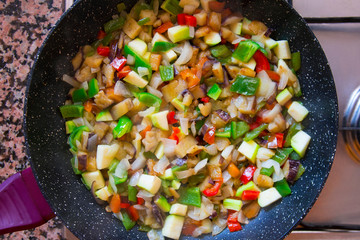 Assorted fresh vegetables in a frying pan. Vegetables cooked on the stove