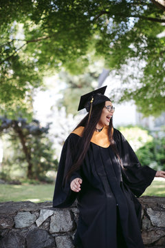 Teenage girl in cap and gown costume.