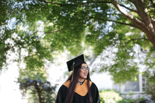 Teenage girl in cap and gown costume.