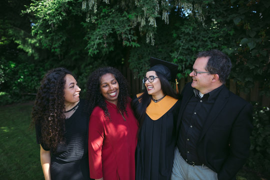 Family of four celebrating a high school graduation