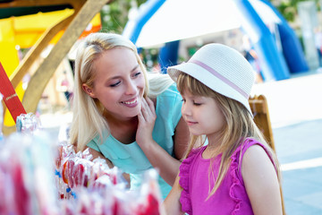 Lovely mother and daughter having fun at a festival