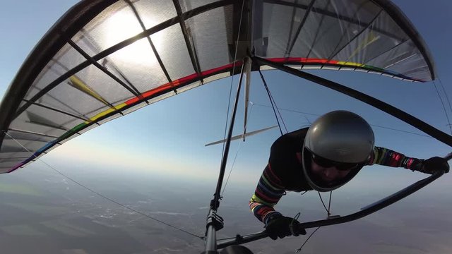 Hang glider pilot on colorful wing flies together with white tailed eagle. Extremely rare footage. Dream to fly like a bird come true. Social distancing in the wild nature far from other people