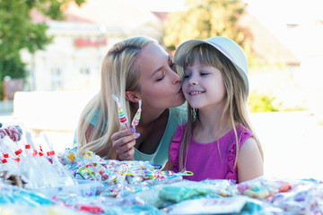 Lovely mother and daughter having fun at a festival