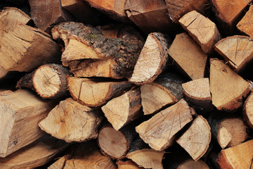 Wooden logs, beams, firewood, frame background. Harvesting for the winter.