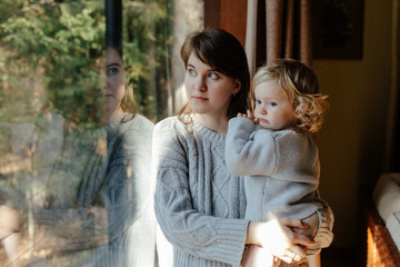 Woman with child standing in modern cottage
