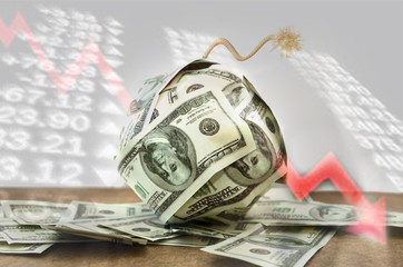 Big bomb of money hundreds of dollars bills with a burning wick on the background of business...
