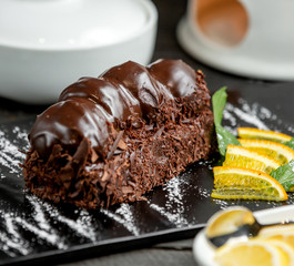 chocolate dessert topped with chocolate dipped profiteroles