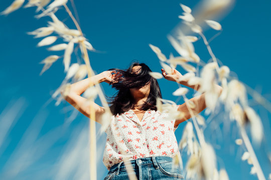 Low Angle View Of Woman Standing In Field