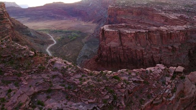 Aerial Drone Footage of Redrock Canyon in Utah Desert Near Moab Reveal Down Cliff Edge Birds Eye View on Kane Creek Road and Car