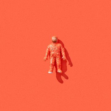 Plastic toy of spaceman with shadow.