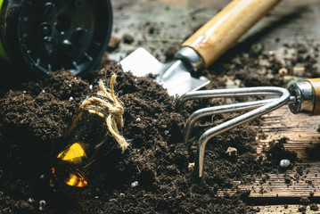 Garden soil, fertilizer and garden tools close up.