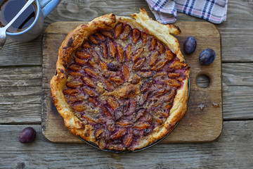 Almond plum cake on puff pastry. Delicious summer breakfast.