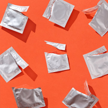 Opened packs from condoms with shadows.