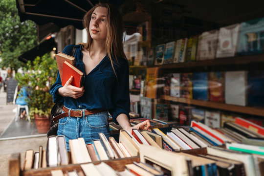 Smart Elegant Caucasian Woman Buying Books At Market