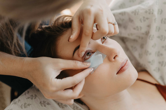 Process of a teenage girl having eyelash extensions put in