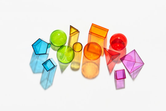 Different colorful shapes on a light background with reflection