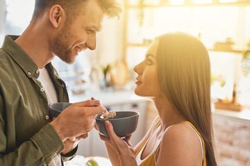 Profile photo of delighted couple that having breakfast