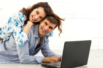 Couple buying online together with a laptop on a desktop at home