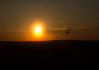 beautiful sunset sky. hang-gliding. hang glider with a motor. hang glider at sunset