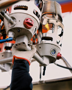 hand of a man controlling a hot air balloon. fire control levers for balloon