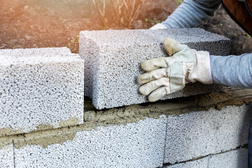 house wall construction - mason laying expanded clay blocks