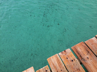 Wooden pier above the crystal clear turquoise colour water at Mallorca.