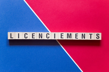 Licenciements - layoffs in French word concept on cubes