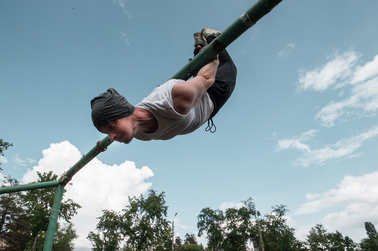 powerful street work-out of the crossfit athlete - doing gymnastics in the playground