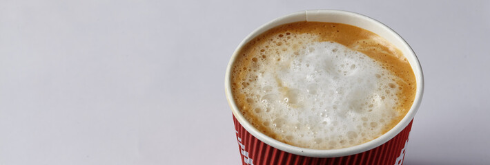 Take-out coffee in opened thermo cup against white.