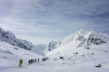 Fototapeta na wymiar Group of skiers touring uphill