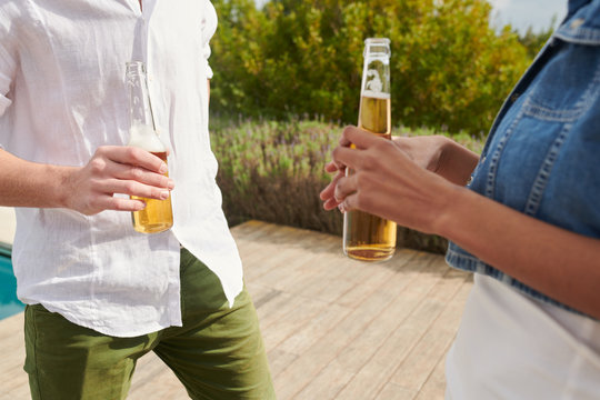 Unrecognizable couple with drinks.