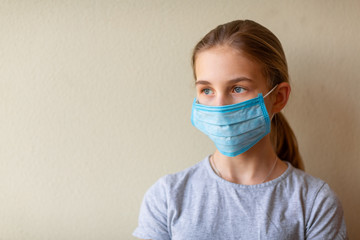 Little teenage girl in medical mask sad and scared