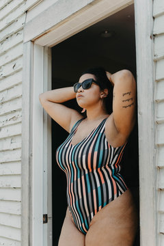 A plus size model wearing a bathing suit in the summer