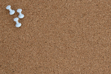 Fototapeta na wymiar Three white tacks in cork board
