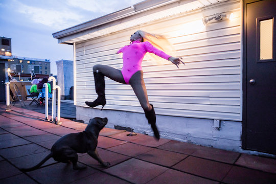 Drag Queen Dancing a Jumping Turn on a Rooftop