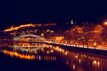 Fototapeta na wymiar Romatic Panoramic night view to the bridge of peace and its reflections, and old town with car trails. Travel destination and night photography in Tbilisi.georgia.2020