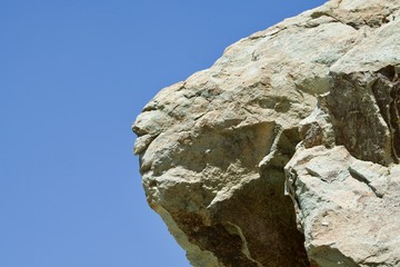 Green rock formation under a blue sky