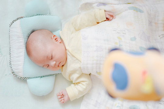 Baby using a pillow, summer