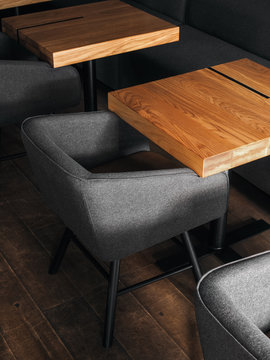 Gray armchairs near tables