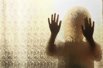 Shadow on a clear glass of a small child